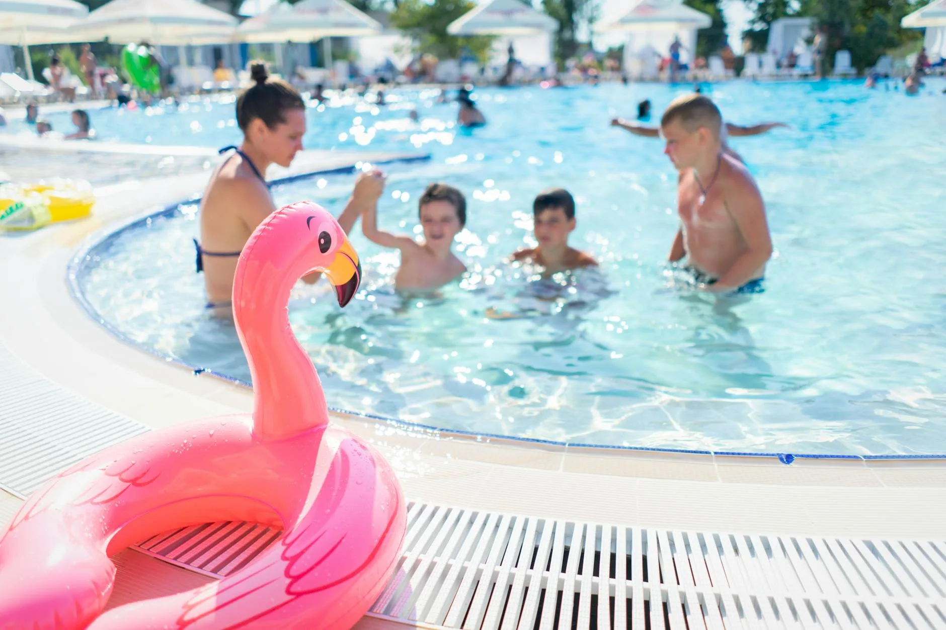 Family enjoying an outdoor pool on a summer day