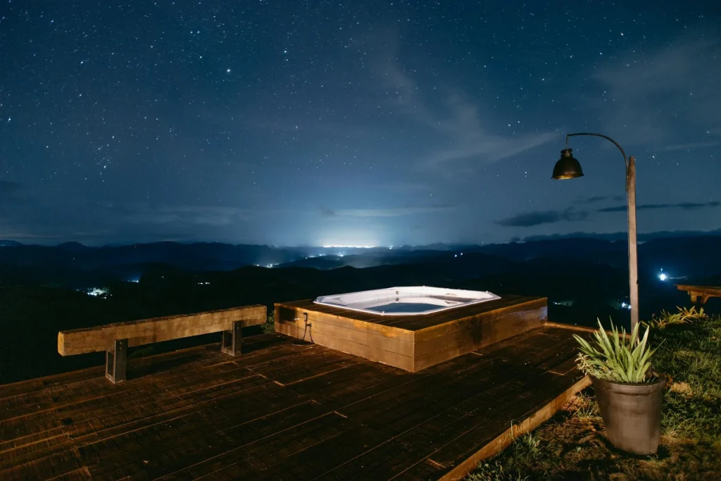 Hard shell hot tub on garden decking in a UK back garden