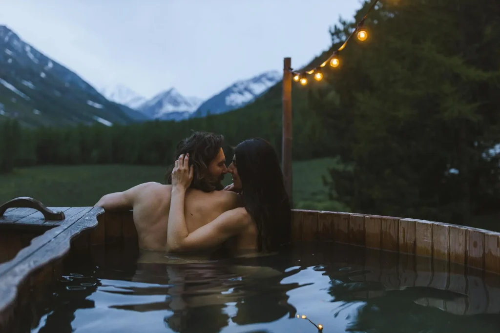 Steaming hot tub in a UK garden setting at dusk