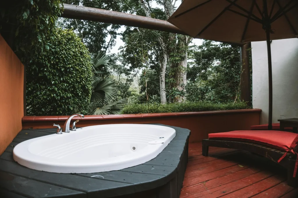 Hot tub on a wooden deck in a back garden