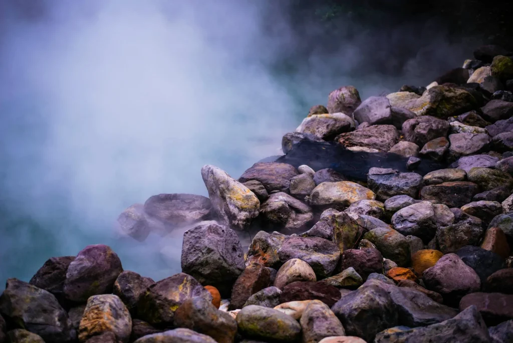 Hot tub in an outdoor garden setting with steam rising