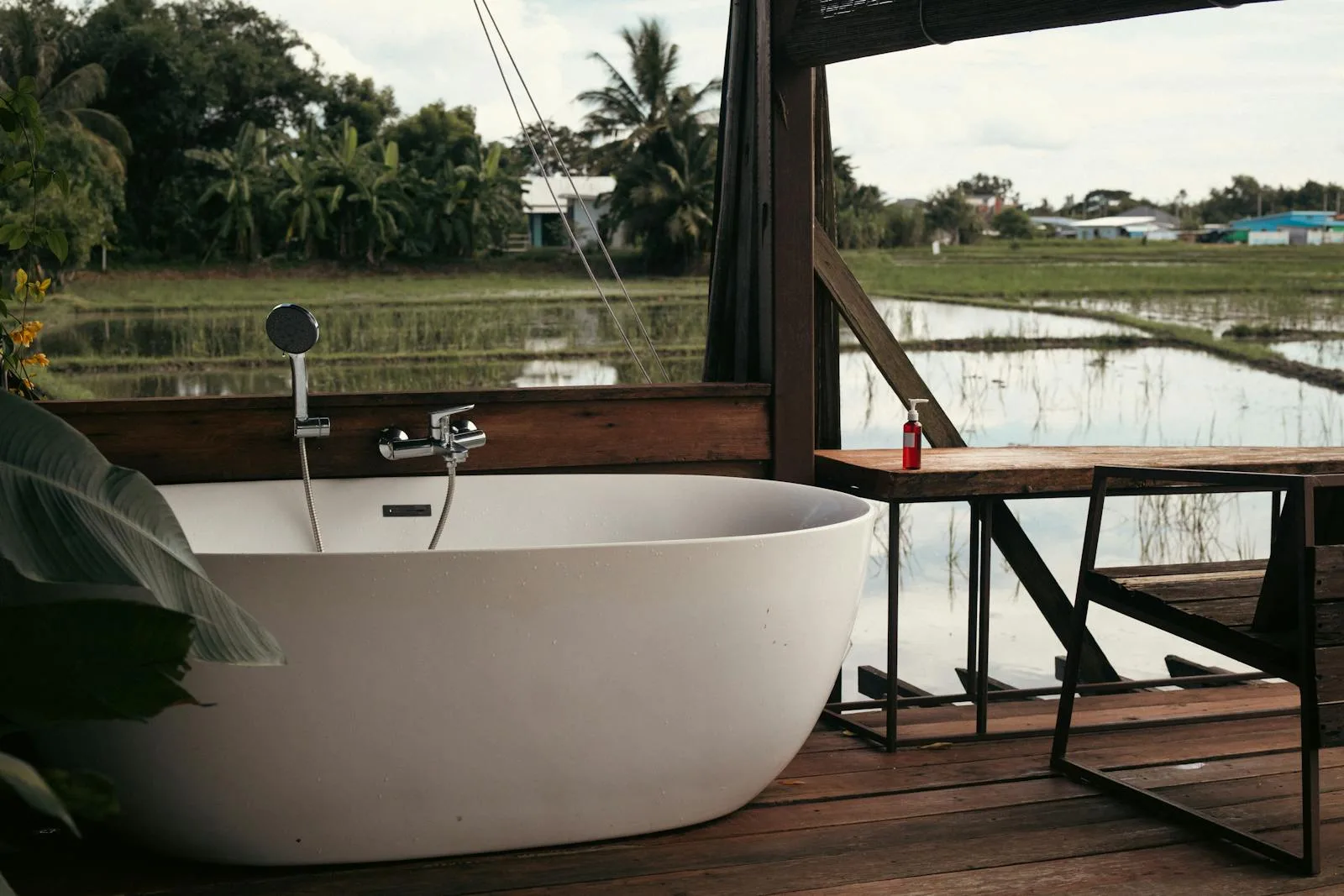 Hot tub set into a wooden deck surround in an outdoor garden setting