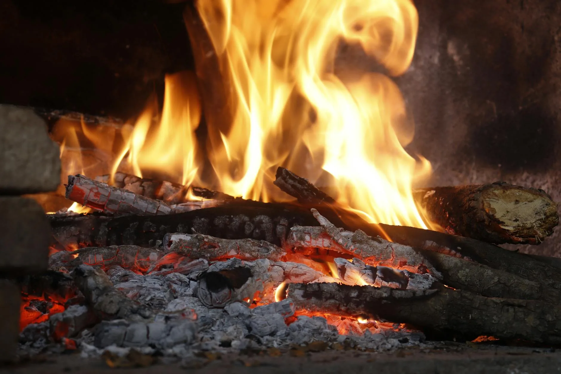 Wood-burning stove heating a hot tub with logs