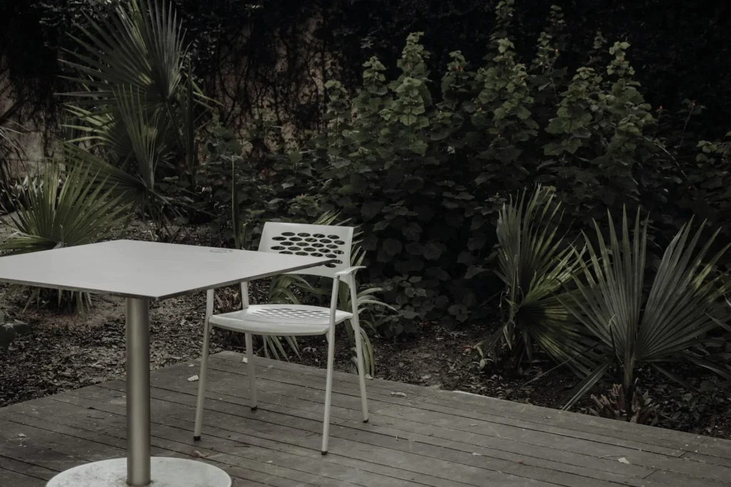 Timber garden deck with outdoor patio furniture in summer