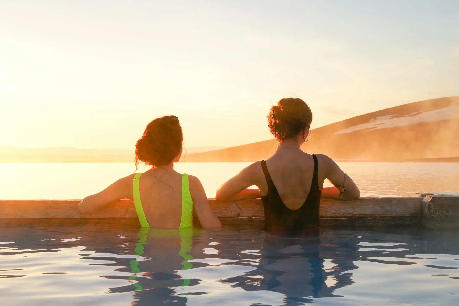 People relaxing in a hot tub on a clear evening