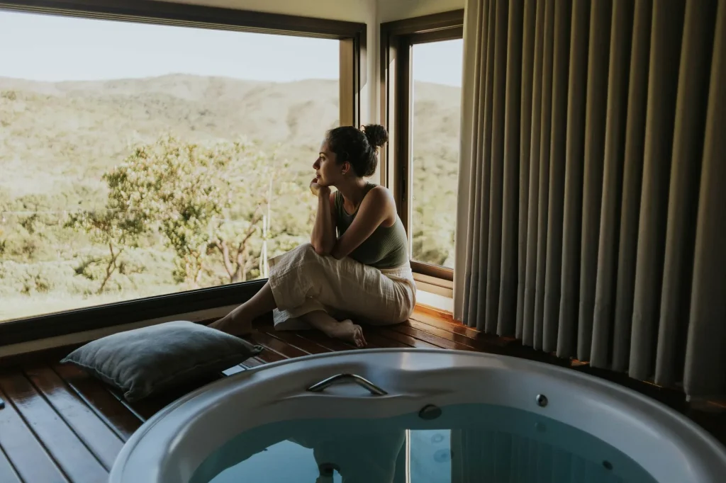 Indoor hot tub spa beside large windows for electricity usage guide